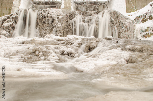 Frozen Aleksupite waterfall in winter day, Kuldiga, Latvia.