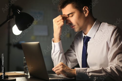 Tired businessman working i...