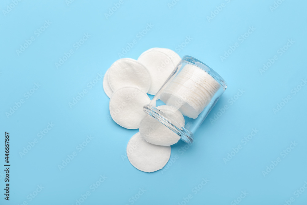 Glass jar with cotton pads on color background Glass jar with cotton pads on color background