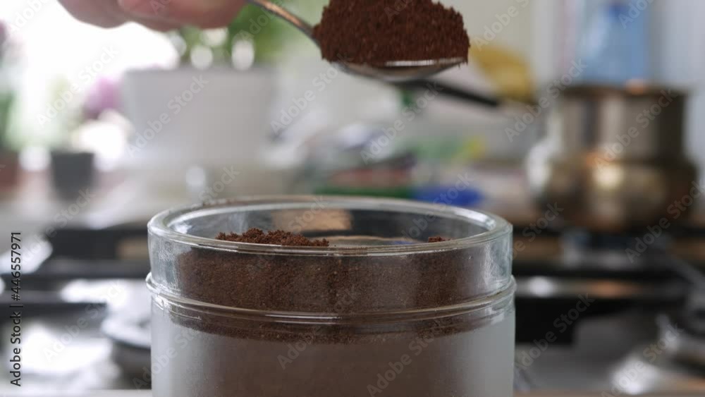 Shooting with a Person Taking a Teaspoon of Freshly Ground Coffee from a Jar. Preparing a Fresh Coffee in the Morning. Shooting with a Person Taking a Teaspoon of Freshly Ground Coffee from a Jar. Preparing a Fresh Coffee in the Morning.