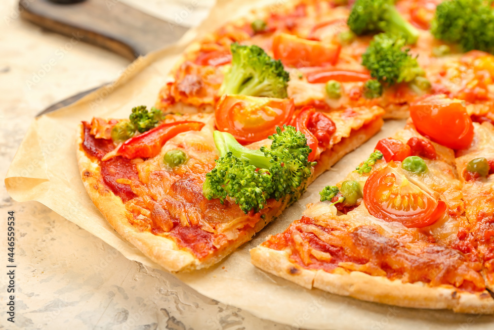 Board with tasty vegetarian pizza on light background, closeup