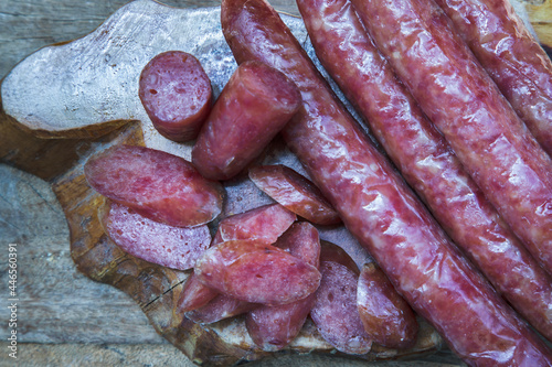 Close-up of Dried Chinese sausage on old wooden table. Asia food style, Top view, Copy space, Selective focus.