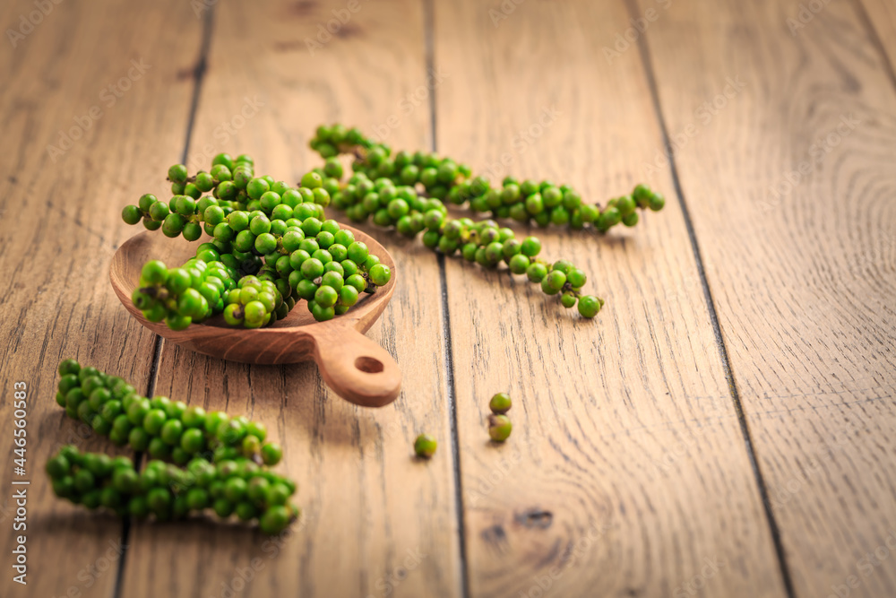 Fresh green peppercorns on wooden kitchen table Fresh green peppercorns on wooden kitchen table