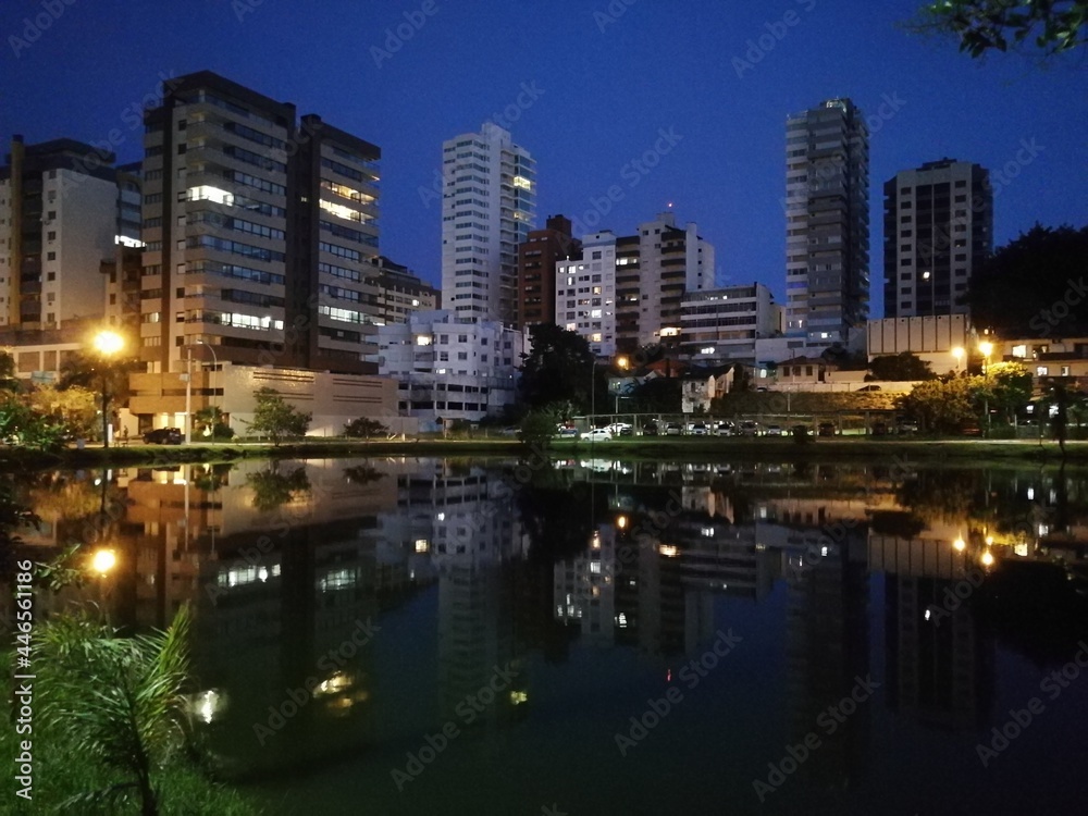 buildings and reflections in a lake at night
