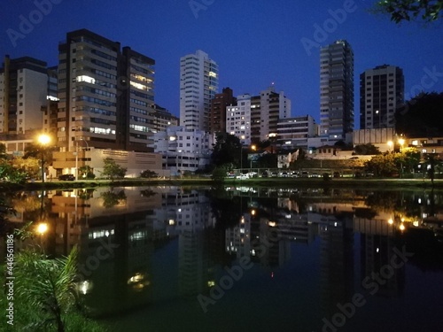 buildings and reflections in a lake at night 