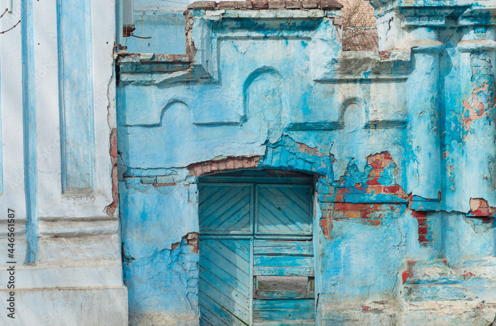 Ancient ruined blue building. Destroyed cyan house. Travel street photo. Turquoise weathered wall.