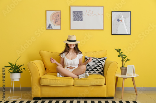 Young woman meditating at home