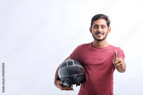 Motorbike concept Young man with black helmet on white background. © PRASANNAPIX