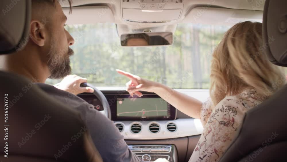 Rear view of couple driving a car on a road trip. Shot with RED helium camera in 8K.
