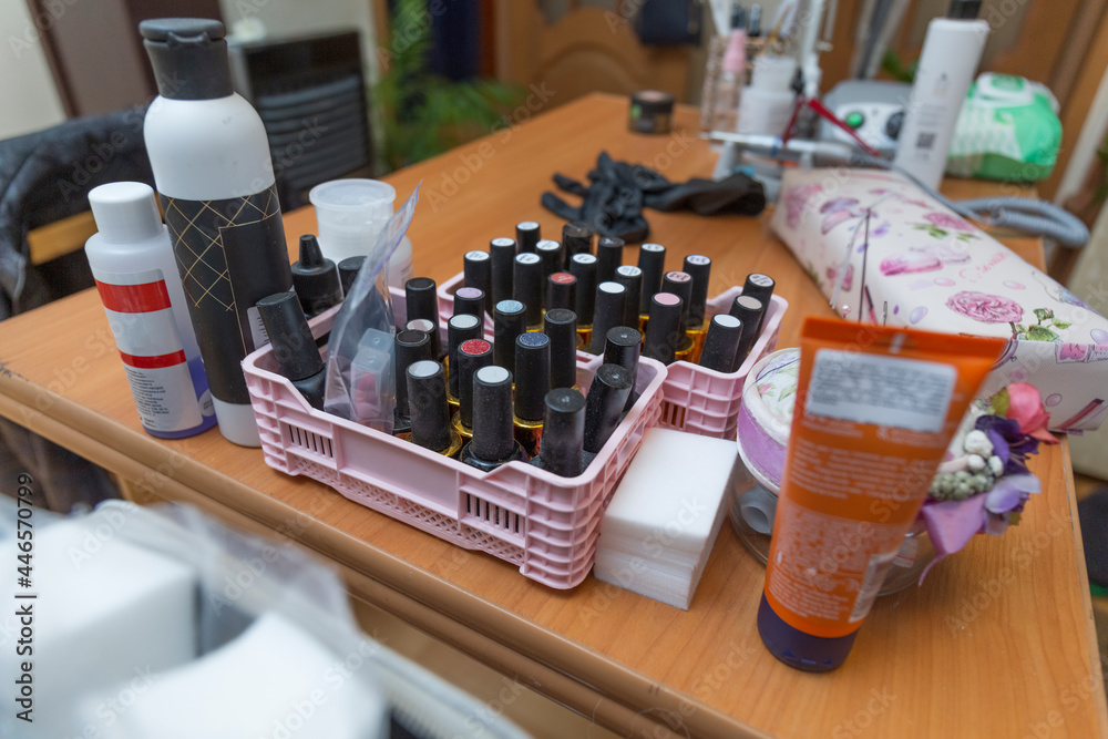 Workplace of a manicurist at home in a pandemic. Close up of antiseptics and nail polishes