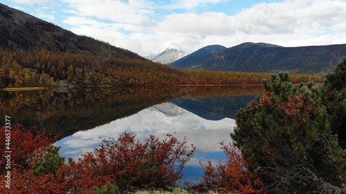 Russia, the region of the Kolyma river. Reflection of mountains in Lake Jack London.