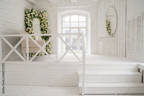 White veranda with table and sofa