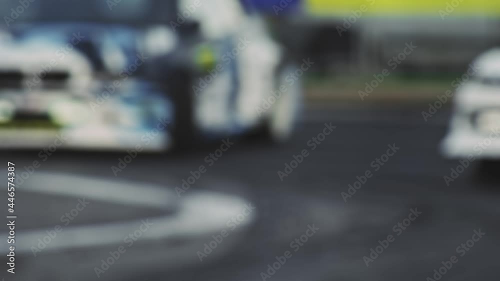 Car drifts on sharp turn of asphalt road. Tire burnout. Smoke from under wheels in slow motion. Racing competitions on high fast speed. Motorsport championship. Closeup. Professional extreme drive Car drifts on sharp turn of asphalt road. Tire burnout. Smoke from under wheels in slow motion. Racing competitions on high fast speed. Motorsport championship. Closeup. Professional extreme drive