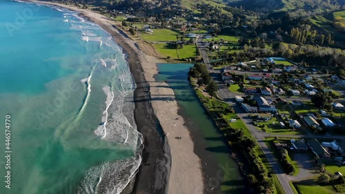 Beautiful drone shot of Tokomaru Bay. Picturesque coastal scenery of sandy beach, the river and housing area. New Zealand photo