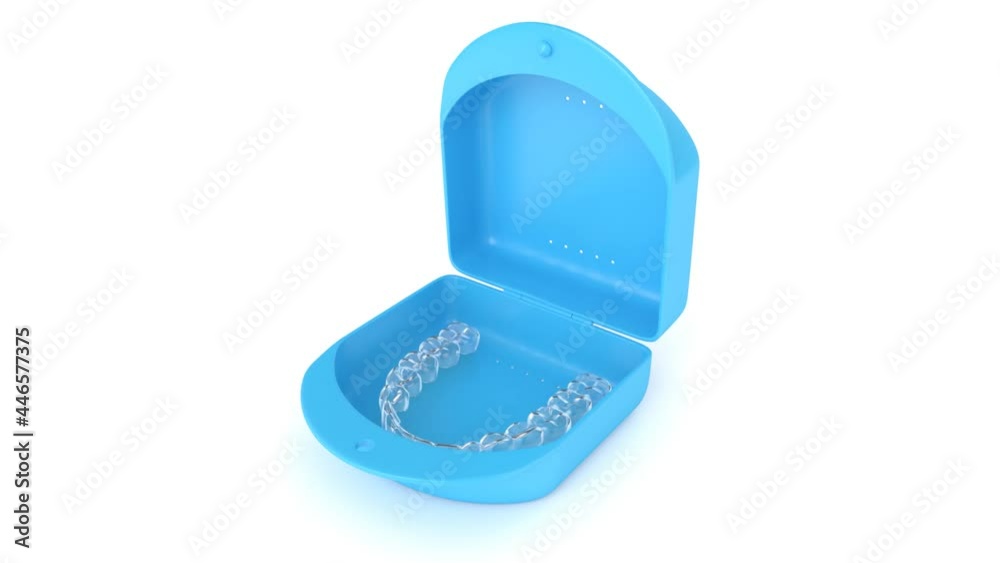 Lower, clear and removable aligner retainer in box case over white background Lower, clear and removable aligner retainer in box case over white background