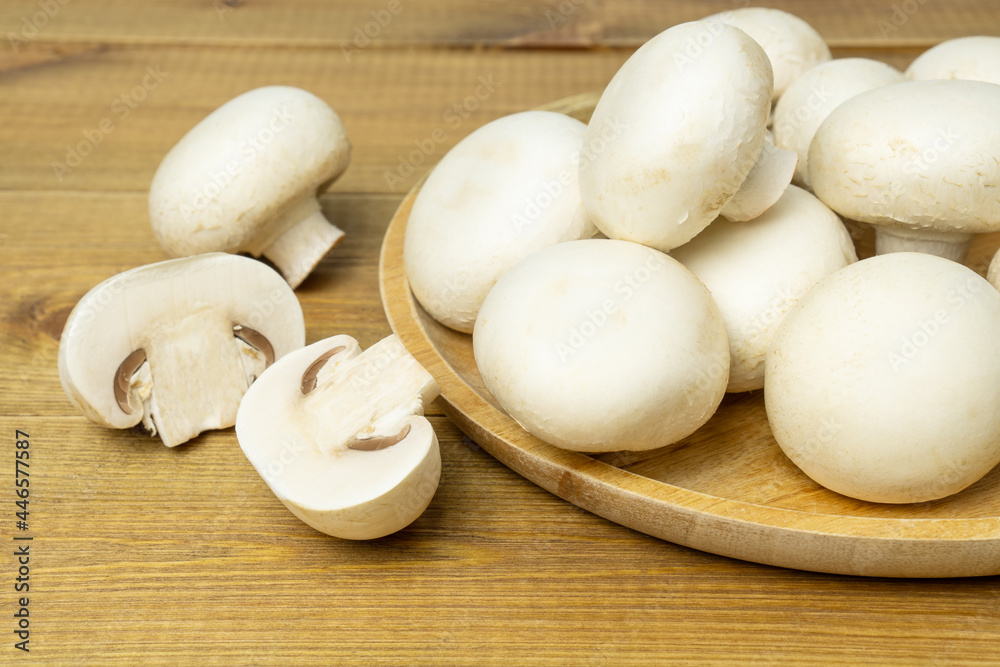 Raw fresh mushroom champignons on wooden table. Raw fresh mushroom champignons on wooden table.