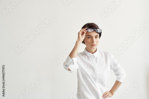 Business woman in a white shirt and glasses in the hands of a professional