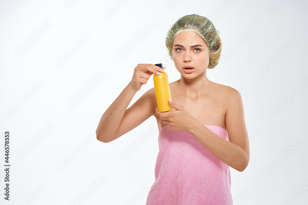 woman with pink towel nude ringlets cream skin care light background woman with pink towel nude ringlets cream skin care light background