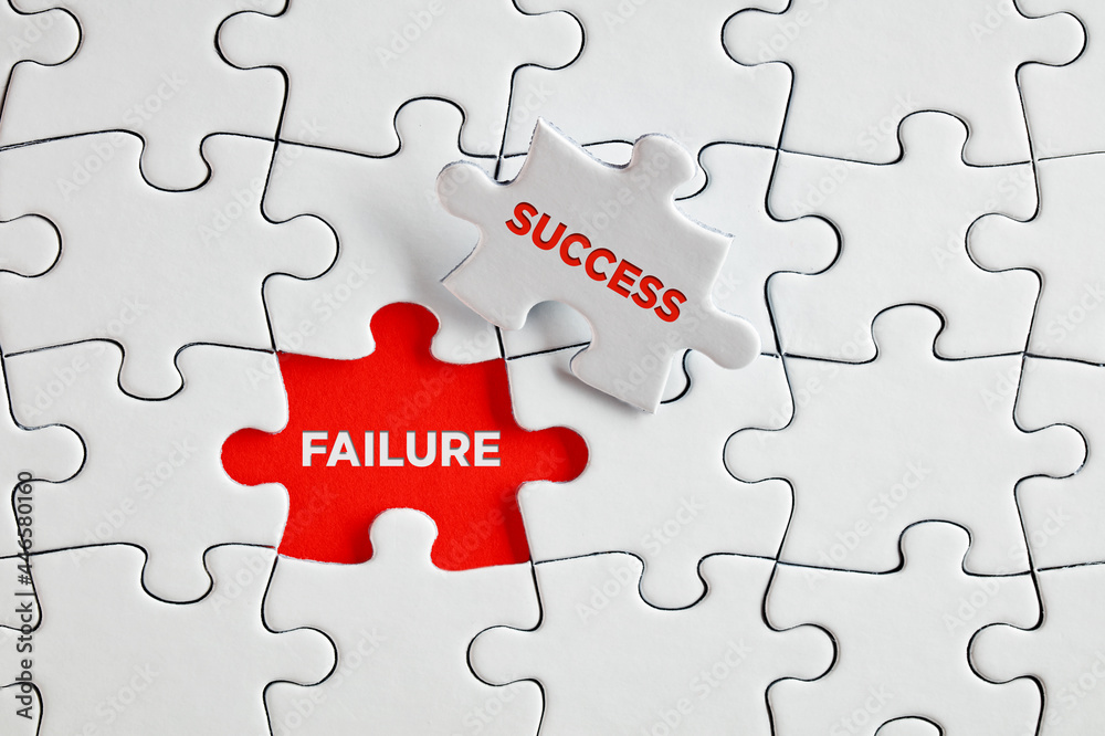 The words failure and success on missing puzzle pieces. The words failure and success on missing puzzle pieces.
