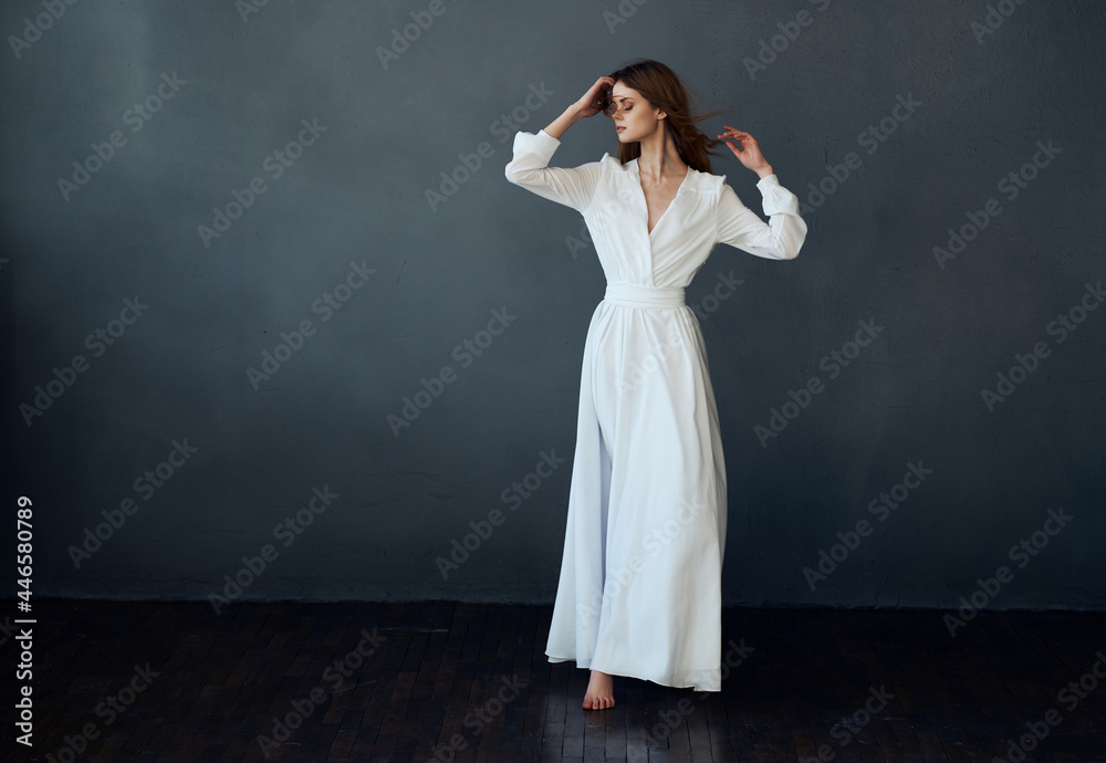 pretty red-haired woman in a white dress fun dance dark background pretty red-haired woman in a white dress fun dance dark background