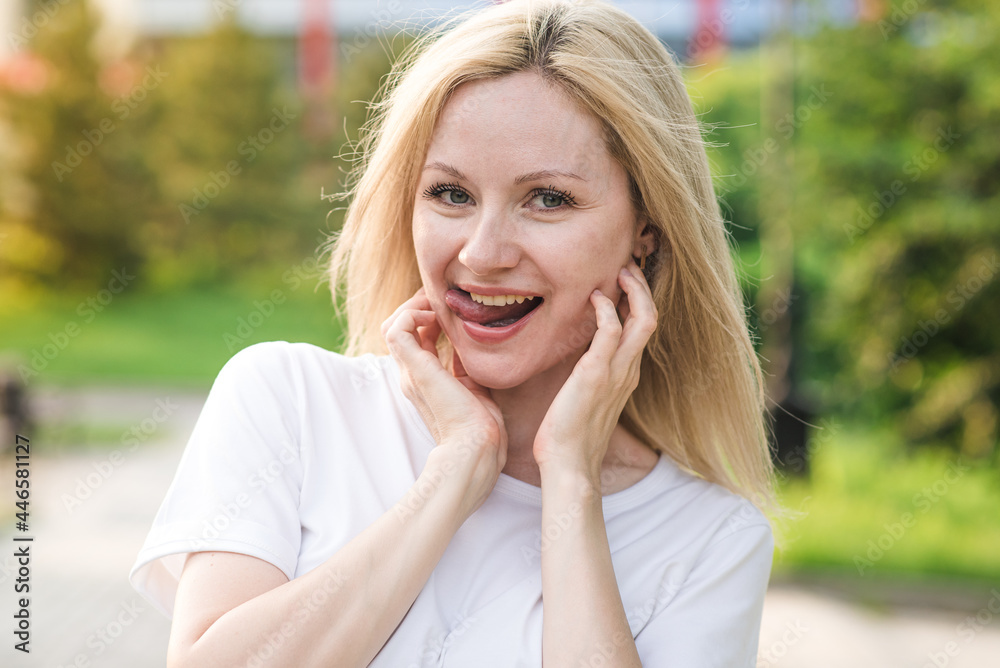 A beautiful and attractive Caucasian woman is showing tongue. Positive behavior. A beautiful and attractive Caucasian woman is showing tongue. Positive behavior.