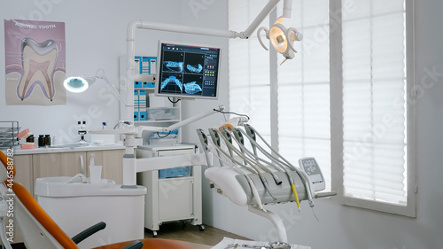 Interior of empty modern stomatology orthodontic hospital bright office ready for dental surgery. Zoom in of professional dentistry drill, with orthodontist chiar prepared for teethcare treatment