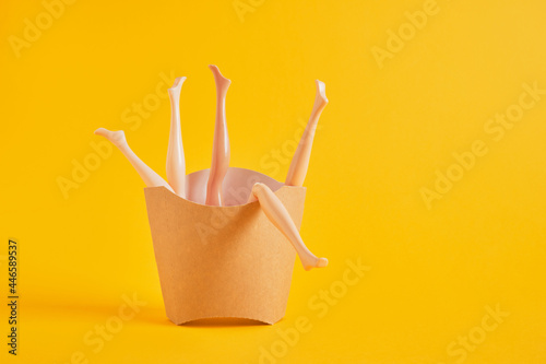 a lot of doll legs in a cardboard box from fries