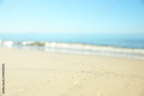 Beautiful sandy beach and sea under blue sky, closeup