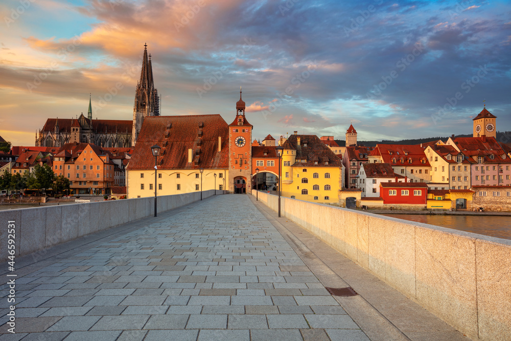 Regensburg, Germany. Cityscape image of Regensburg, Germany with Old Stone Bridge over Danube River and St. Peter Cathedral at summer sunrise.