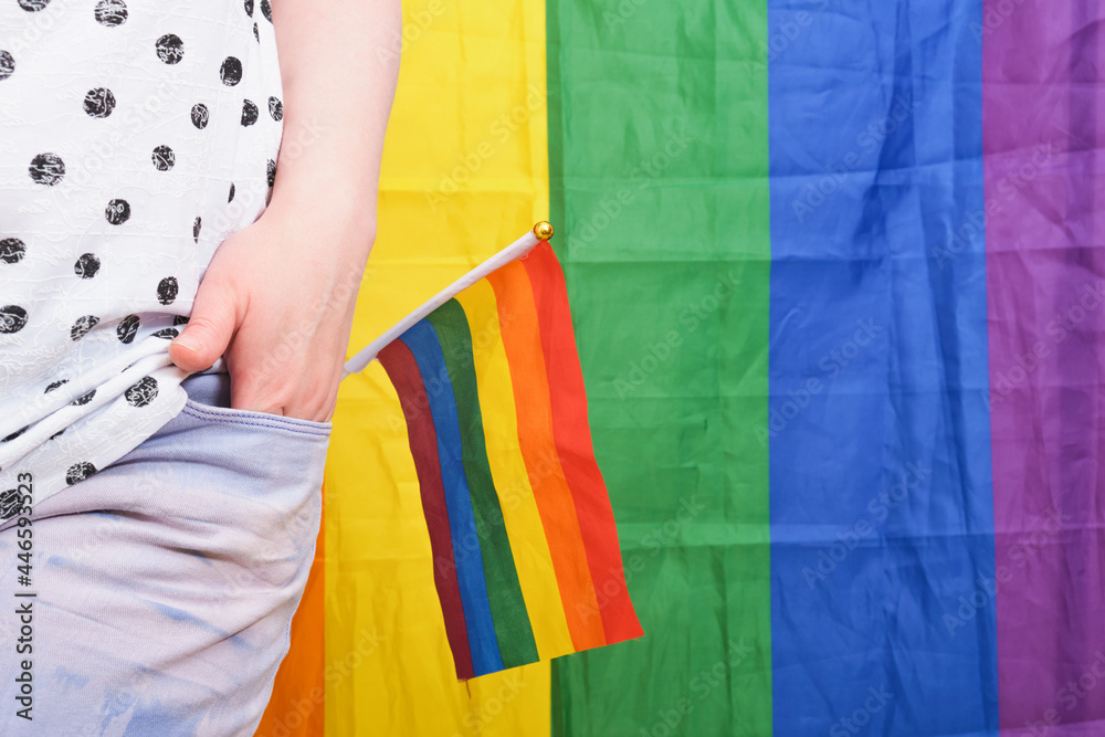 Rainbow LGBT flag in the back pocket of jeans, concept of gender equality. Rainbow LGBT flag in the back pocket of jeans, concept of gender equality.