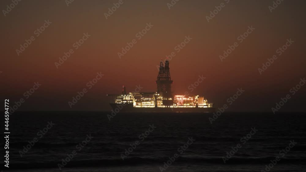 Oil Rig platform in Atlantic ocean glowing in evening sky Oil Rig platform in Atlantic ocean glowing in evening sky