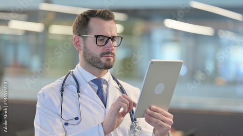 Portrait of Young Male Doctor using Digital Tablet