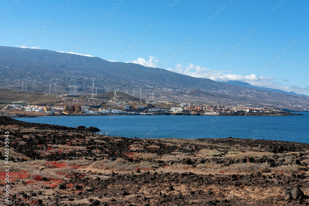 Partial views of Arico municipality from Poris de Abona, with tranquil coastal villages settled on the arid volcanic land and the wind turbines scattered on the hills, Tenerife, Canary Islands, Spain
