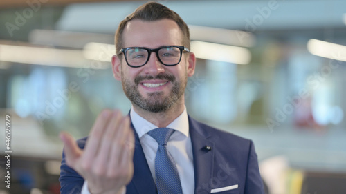 Portrait of Middle Aged Businessman Pointing at Camera, Inviting