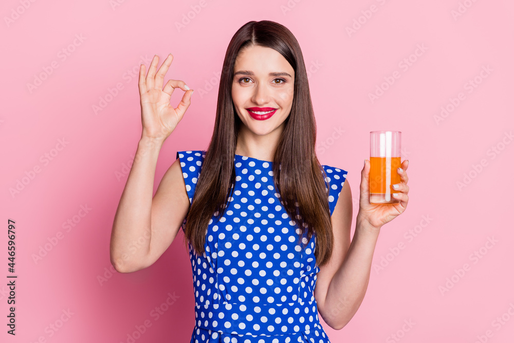 Photo of young woman happy positive smile show okay perfect sign recommend fresh juice isolated over pastel color background Photo of young woman happy positive smile show okay perfect sign recommend fresh juice isolated over pastel color background