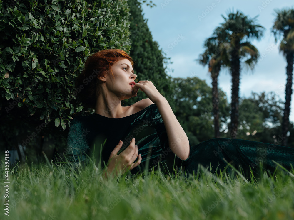 woman in green dress lies on the grass Fairy garden nature woman in green dress lies on the grass Fairy garden nature