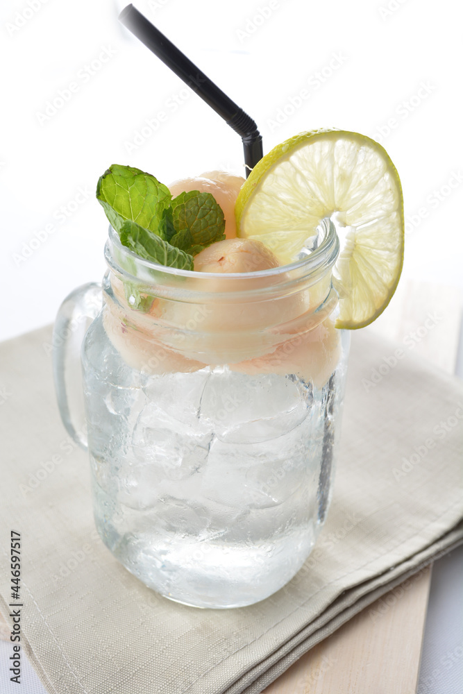 cold iced lychee fruit juice with lemon mint leaf in glass jar white background asian beverage halal menu cold iced lychee fruit juice with lemon mint leaf in glass jar white background asian beverage halal menu