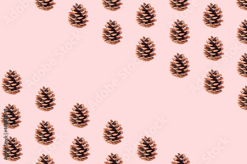 Autumn pattern made of pinecones on pastel beige background. Flat lay. Fall concept with copy space.