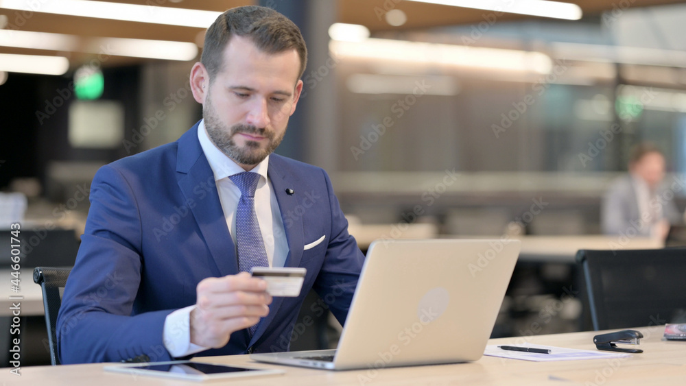 Successful Online Payment on Laptop by Middle Aged Businessman