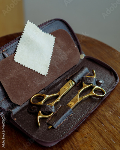 Barber Hairdresser Tool Set in Open Bag on Wooden Background