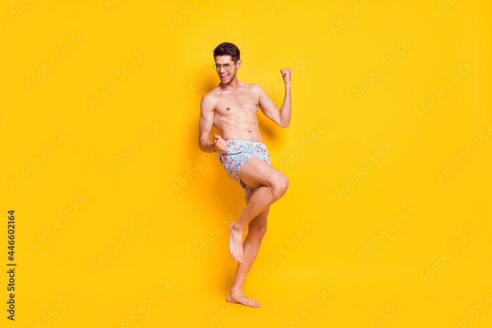 Full length body size view of attractive shirtless cheerful guy dancing weekend day isolated over bright yellow color background