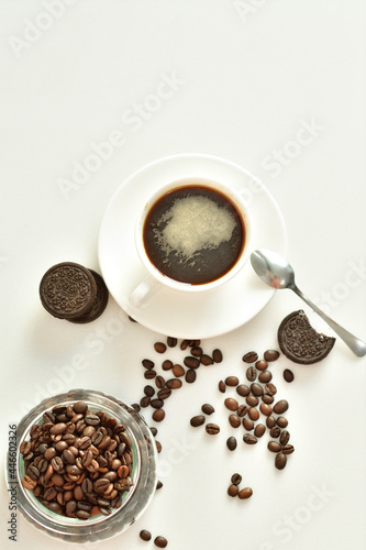 cup of black coffee and coffee beans, a piece of chocolate