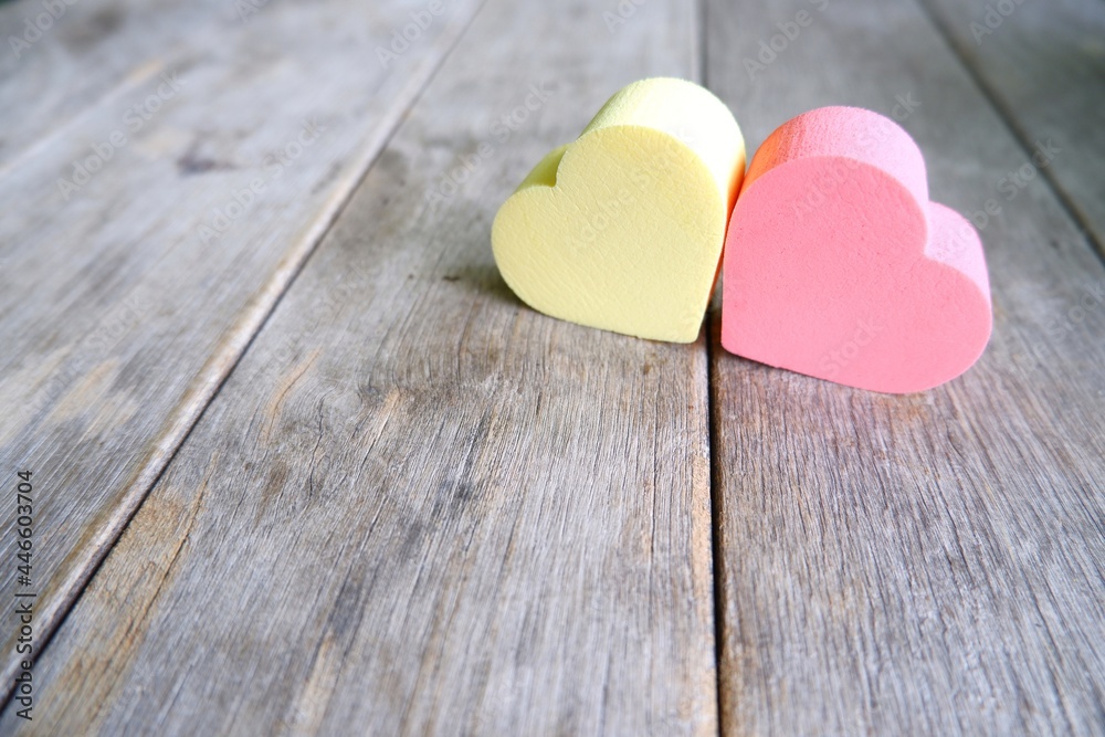 Pink and yellow sponge on wooden table on natural light background. Pink and yellow sponge on wooden table on natural light background.