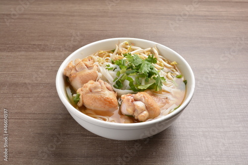 cook hot clear soup bowl with chicken drum stick and vermicelli noodle mee and vegetables in wood background healthy asian halal menu