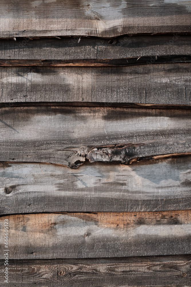 Old fence made of uneven horizontally placed boards. Wood planks texture. Old fence made of uneven horizontally placed boards. Wood planks texture.