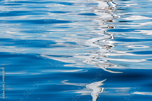 Reflection of yacht masts in the water.