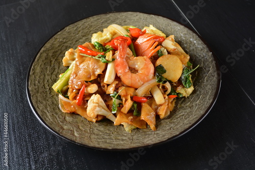 stir fried kway teow rice noodle phad thai with mixed seafood and vegetables in black background healthy asian halal menu