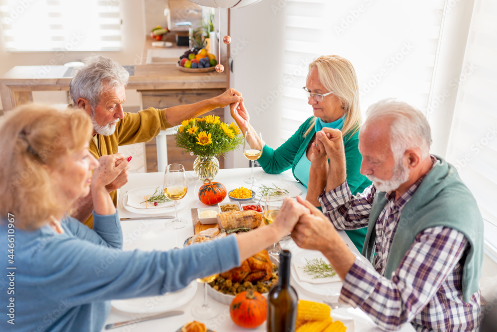 Senior people praying before Thanksgiving dinner Senior people praying before Thanksgiving dinner
