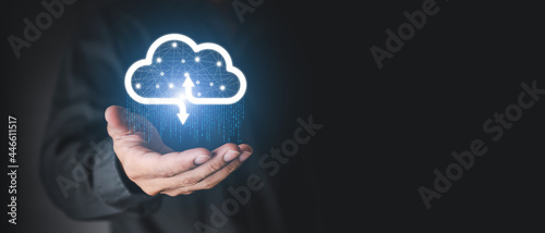 Businessman holding a cloud data icon with light and the binary number 1010. The concept of digital traffic is connected to the cloud. Insurance Business computer security concepts.