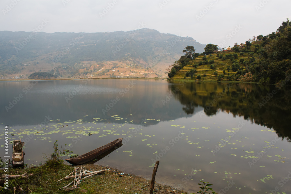 old wooden boat on the shore of the lake in nepal